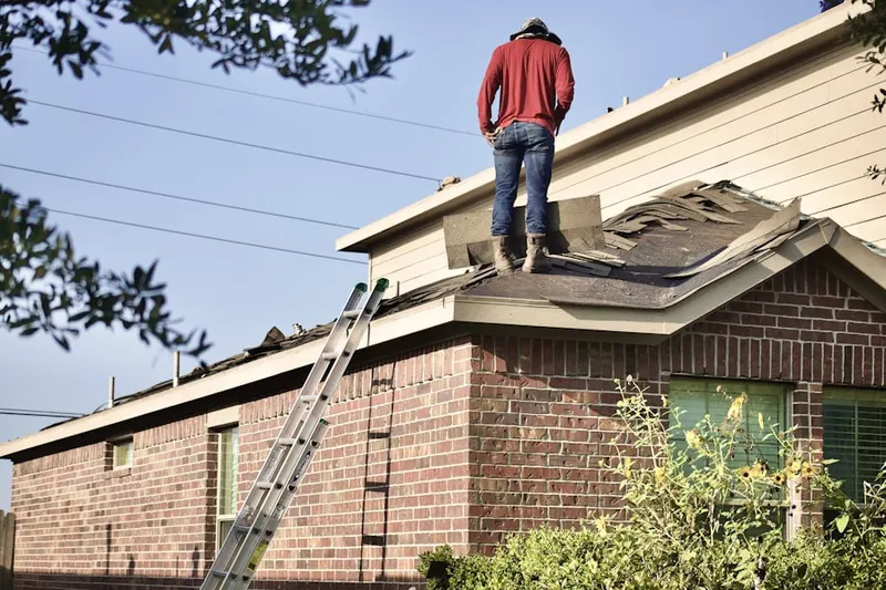 Professional roofer working on a residential roof in Griggstown